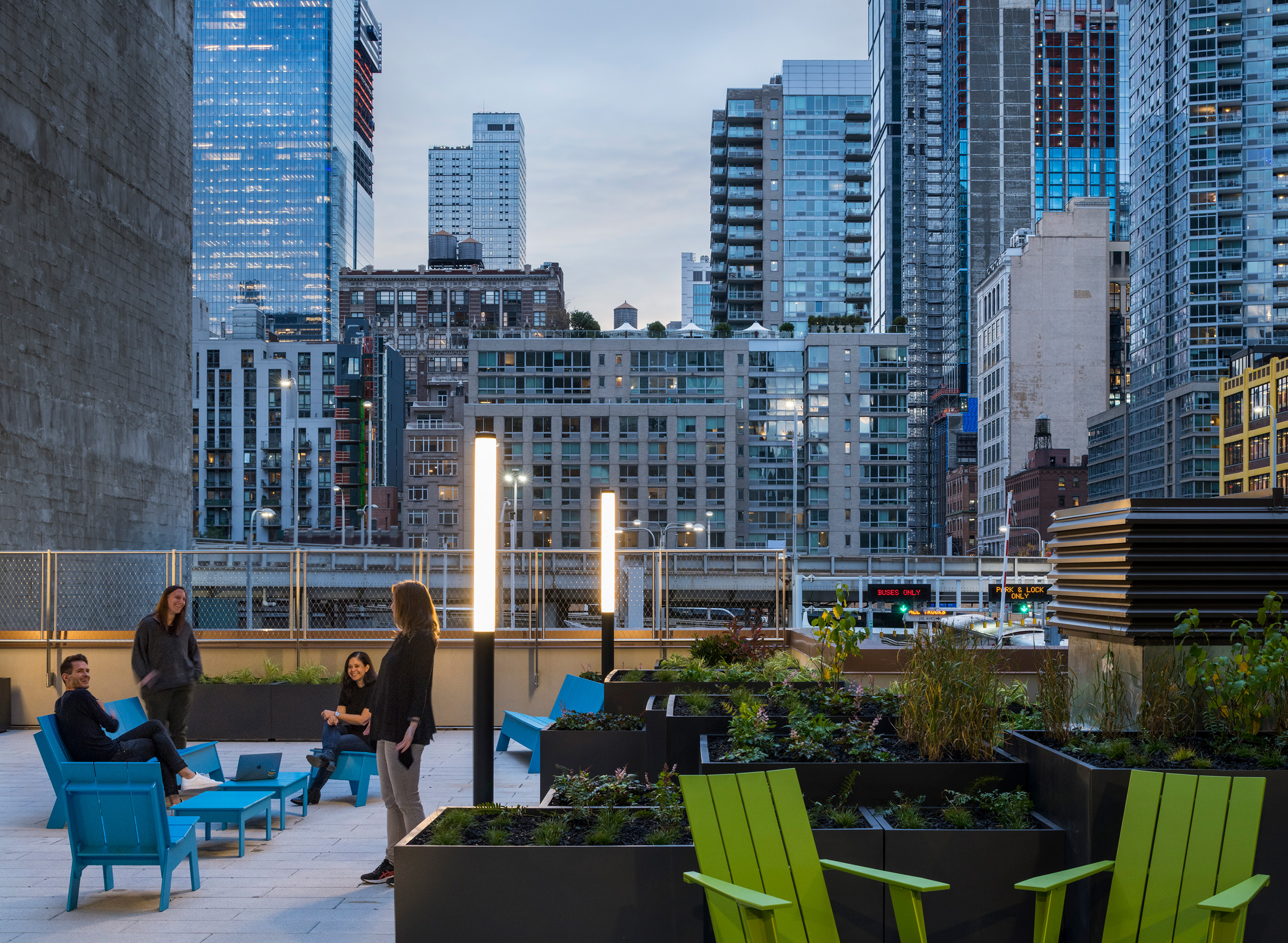 Group of people on rooftop patio at sunset