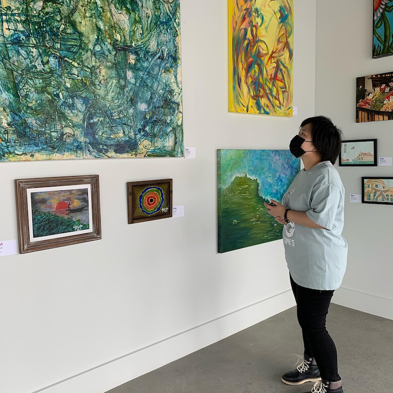 A patron takes in the latest collection at Arthaus's gallery, in Allston, Mass. Photo: Unbound Visual Arts