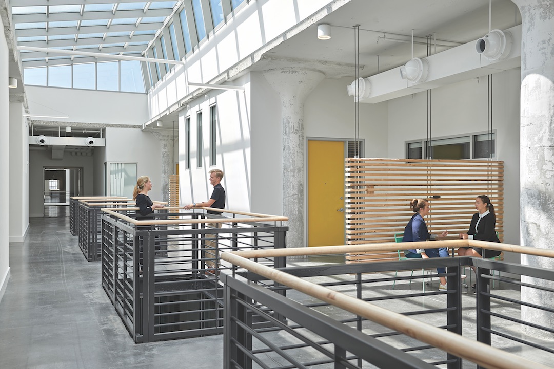 Four lightwells bring the outside into the residential sections of Crosstown Concourse. 