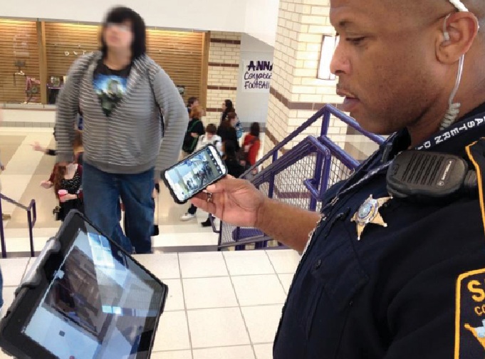 Collin County Sheriff Deputy George White checks a hallway in one of Anna (Texas