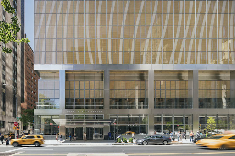 Facade and ground level with cars in front