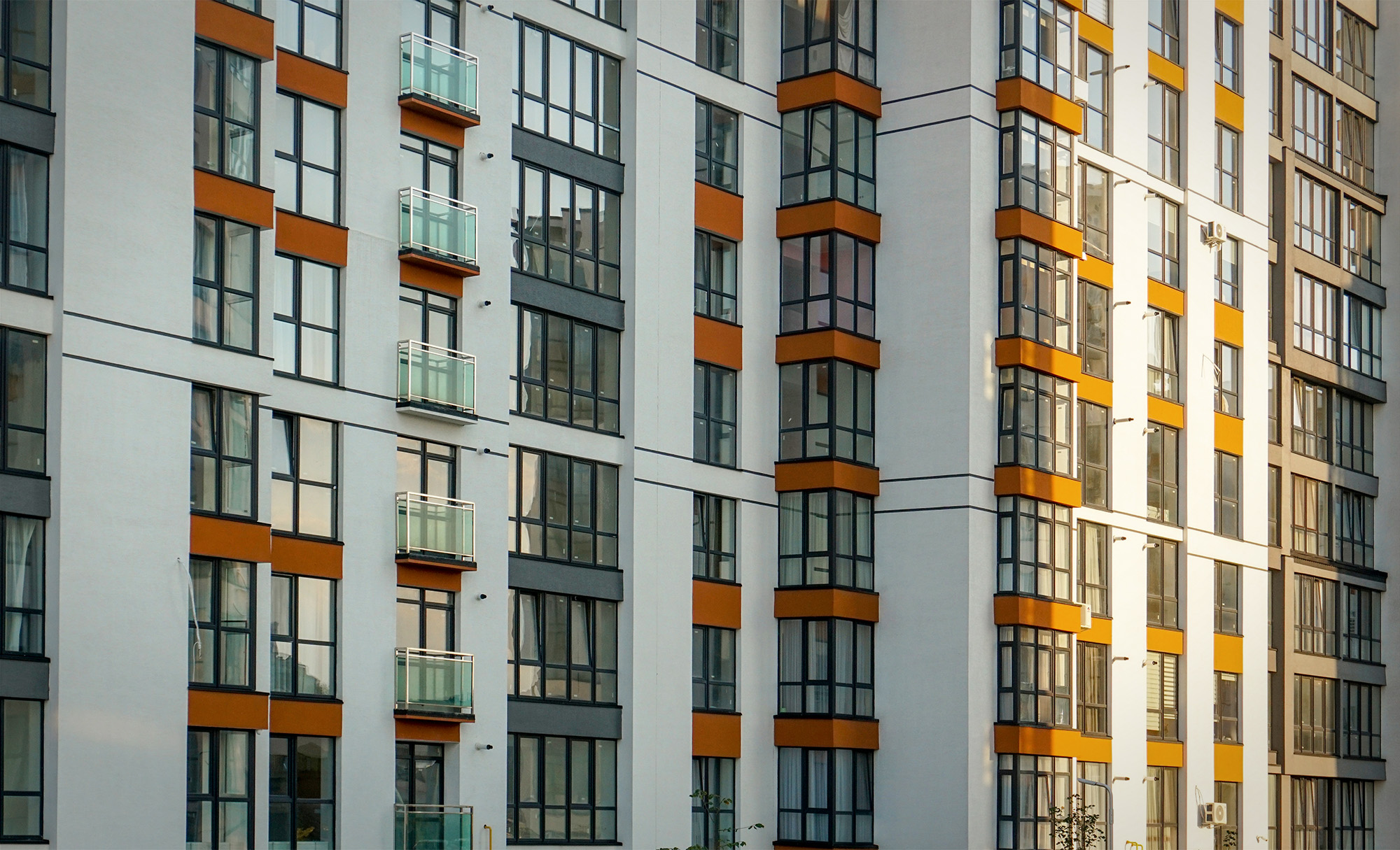 Facade of a multi-apartment residential building with windows and balconies