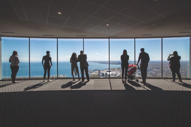 People looking out Cn Tower's new glass