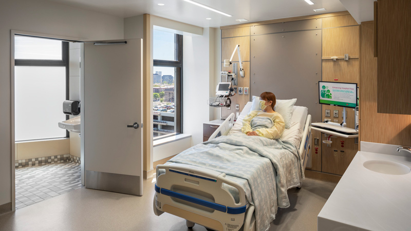 Woman wearing a mask in a hospital bed