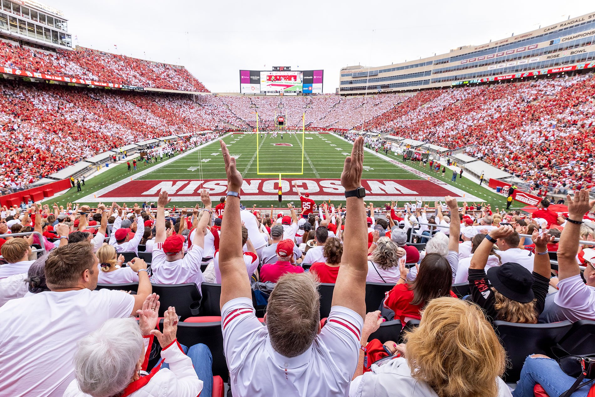 Cheering crowd in football sports arena