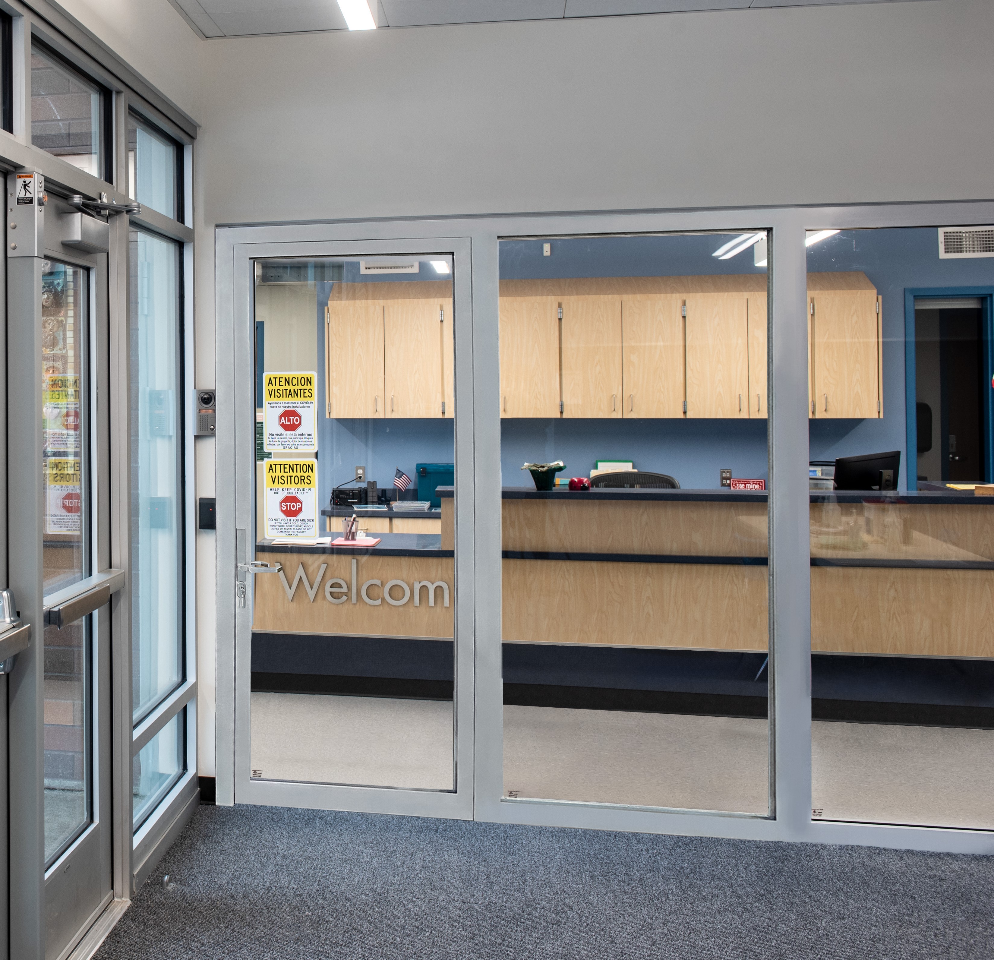 Multifunctional, fire-rated glass maintains code compliance in secure entry vestibule design.