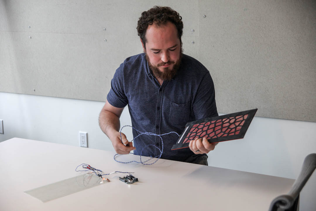 Dane Stokes, a Design Technology Specialist with ZGF Architects, shown with floor sensors, AEC Innovators, BD+C