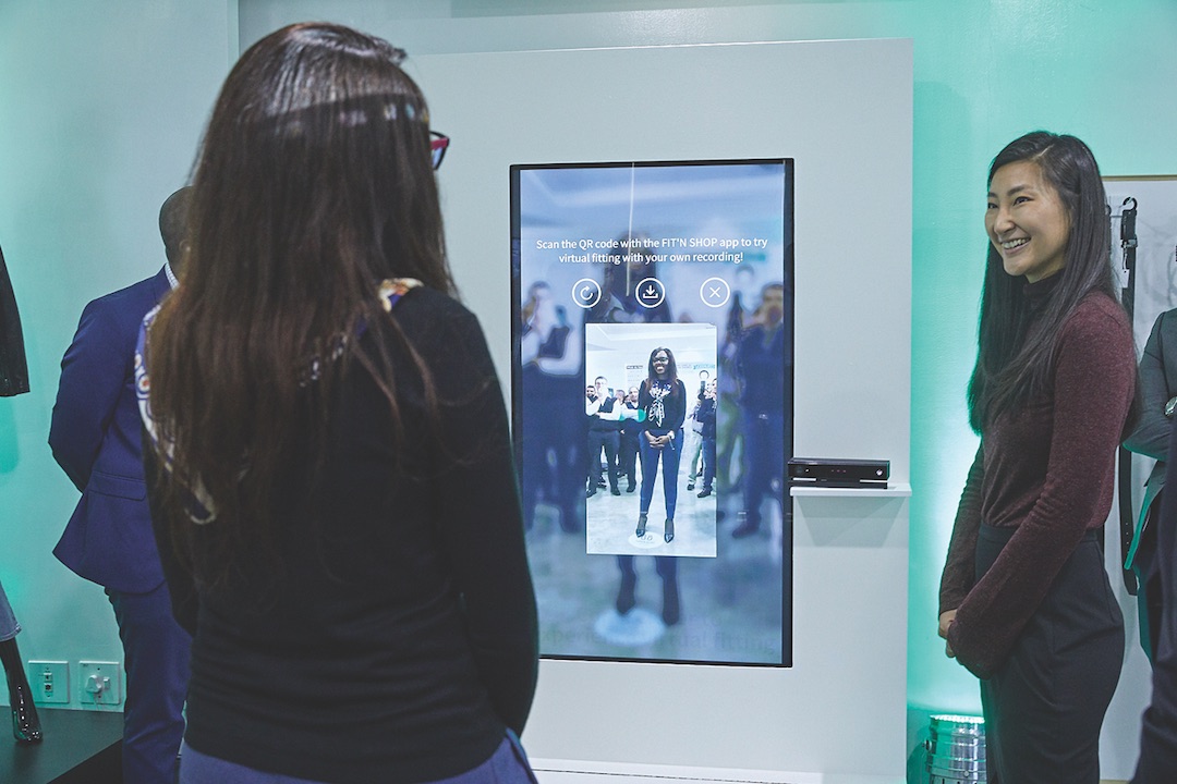 Woman in front of integrated screen in retail store