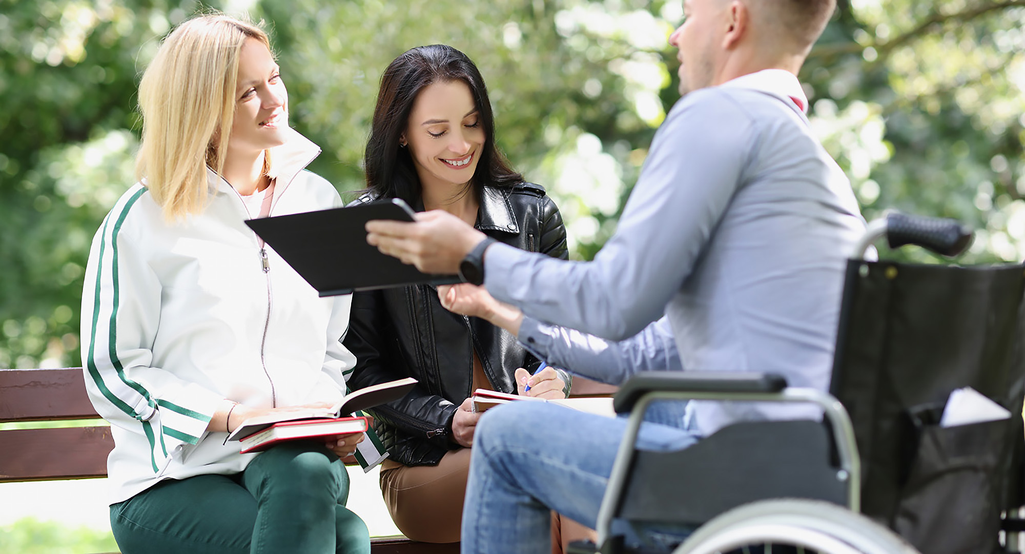 College student in wheelchair having discussion with other students