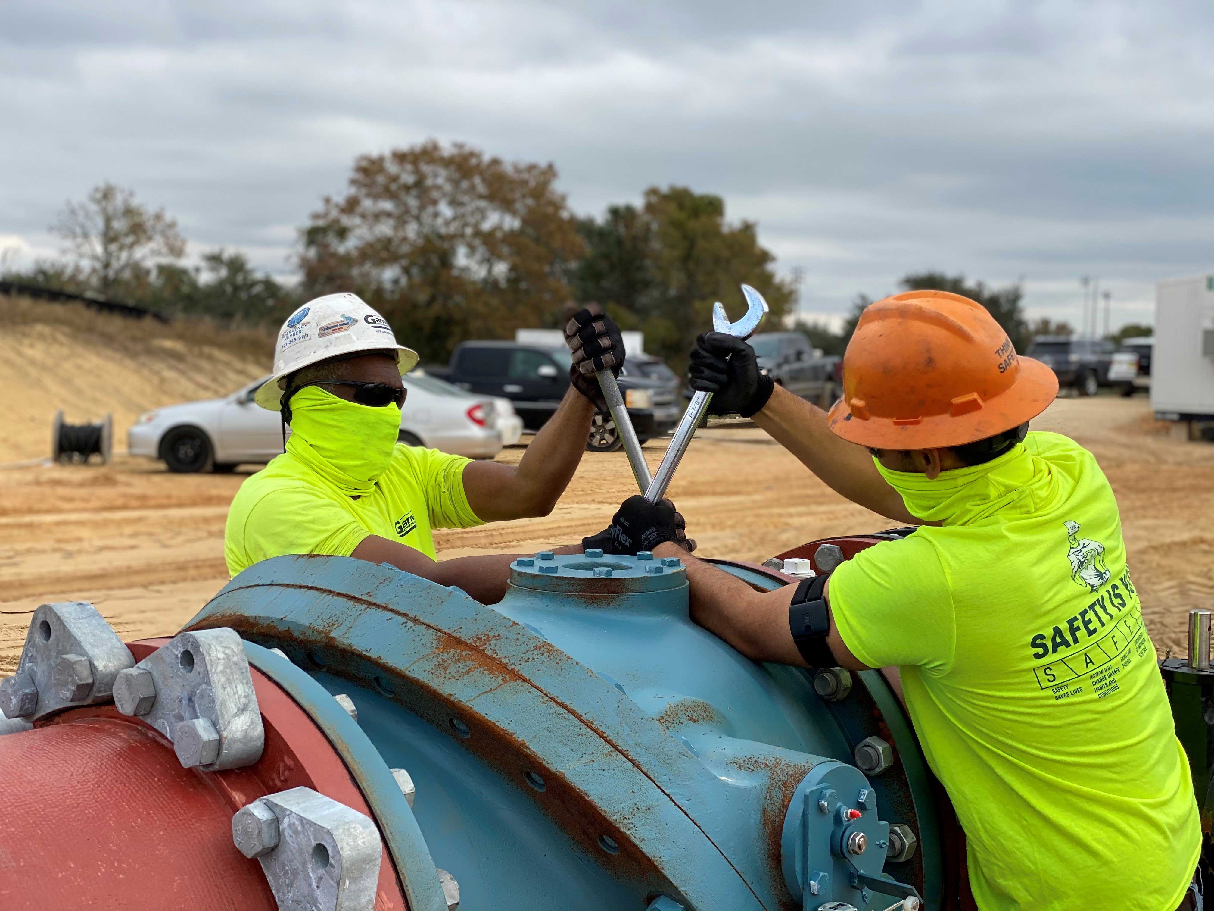 Garney Construction workers wearing Kenzen heat stress devices on their arms