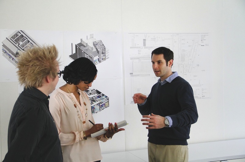 Jared Krieger (right) conducts a project coordination meeting with two of his Ge