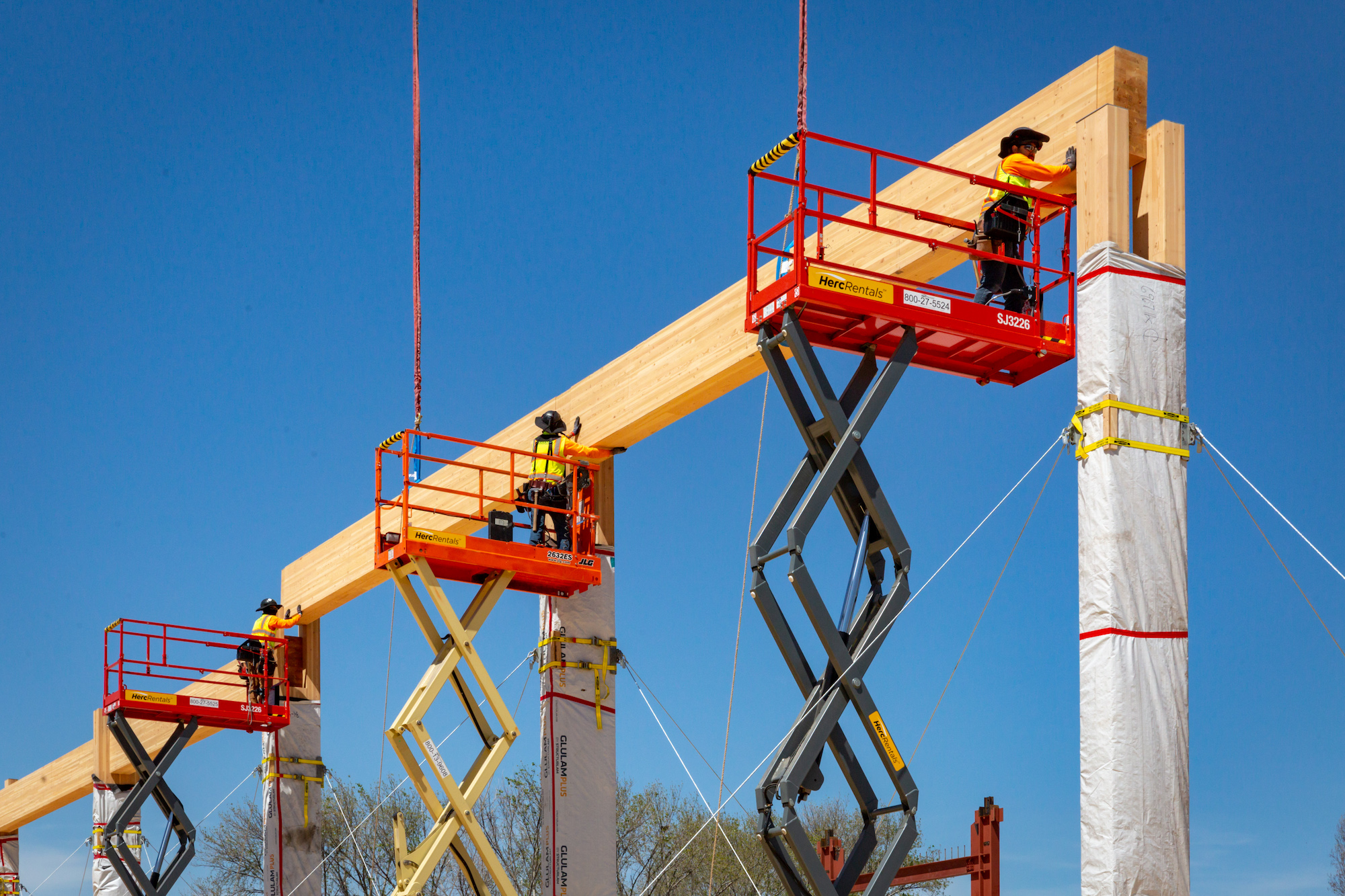 Workers put mass timber beams in place on a timber project in early construction stage. Photo: Marco Zecchin, Image Center