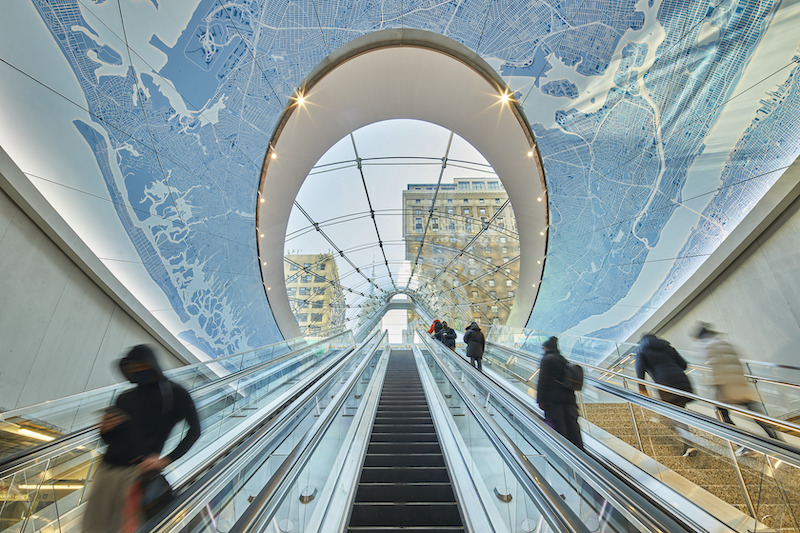 Escalators leading to train station concourse