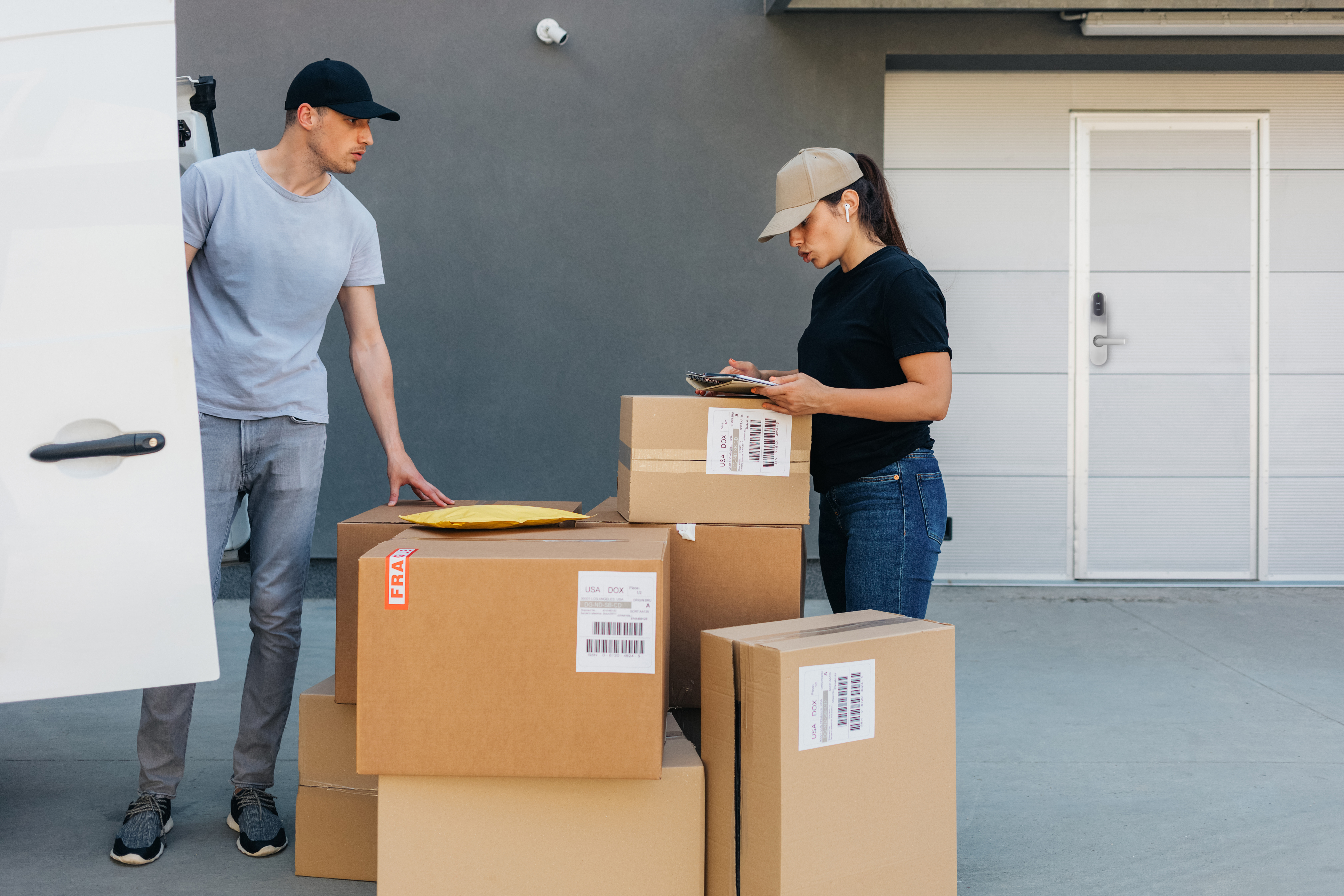 Man and woman with a lot of boxes, open van door