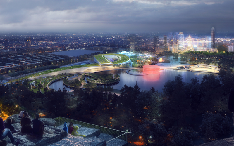 Aerial view of the museum at night with the city in the background