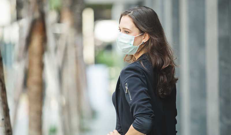 Woman wearing a mask outside