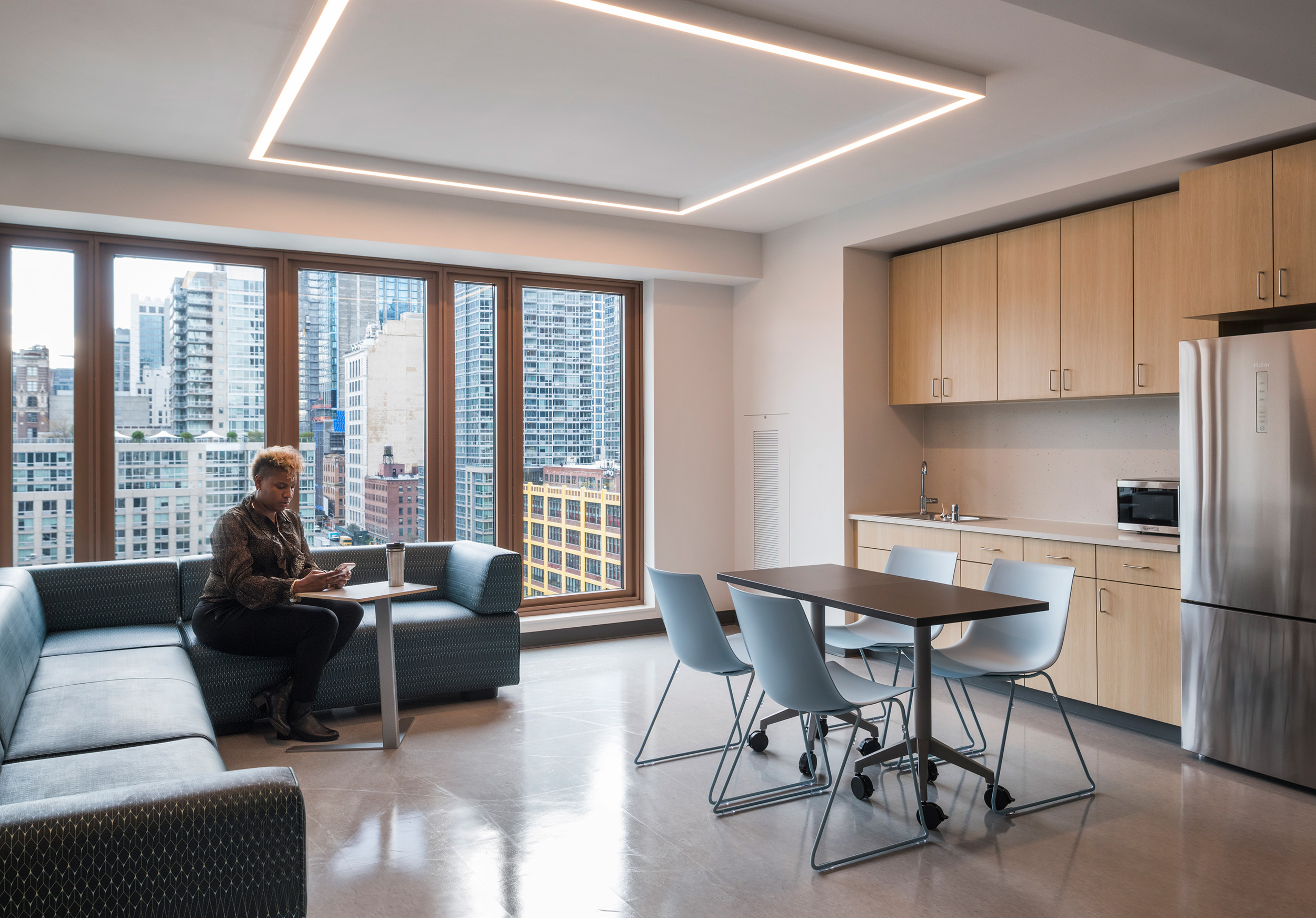 Person sitting in modern multifamily affordable apartment