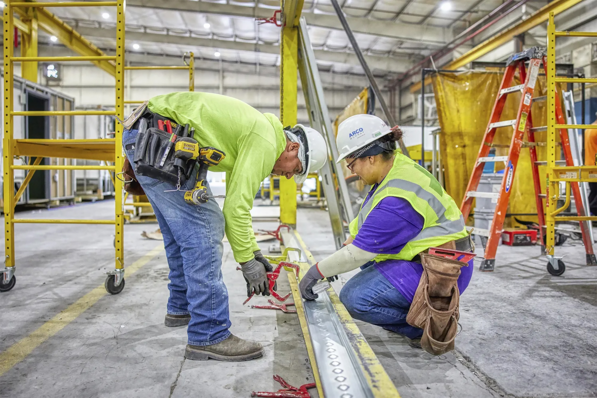 A certified supervisor overseeing employee during construction