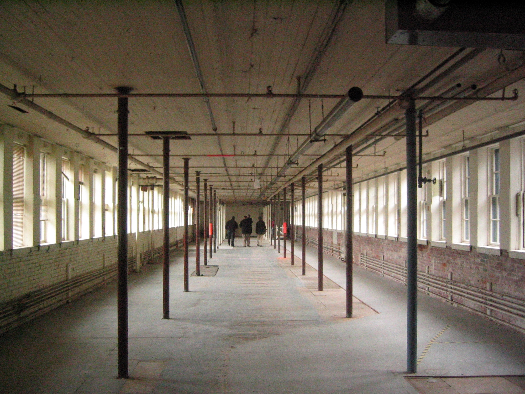 Before and after photos of the Waltham Watch Factory conversion to residential. The width of the floor plates are 32 feet.  Image  Bruner / Cott