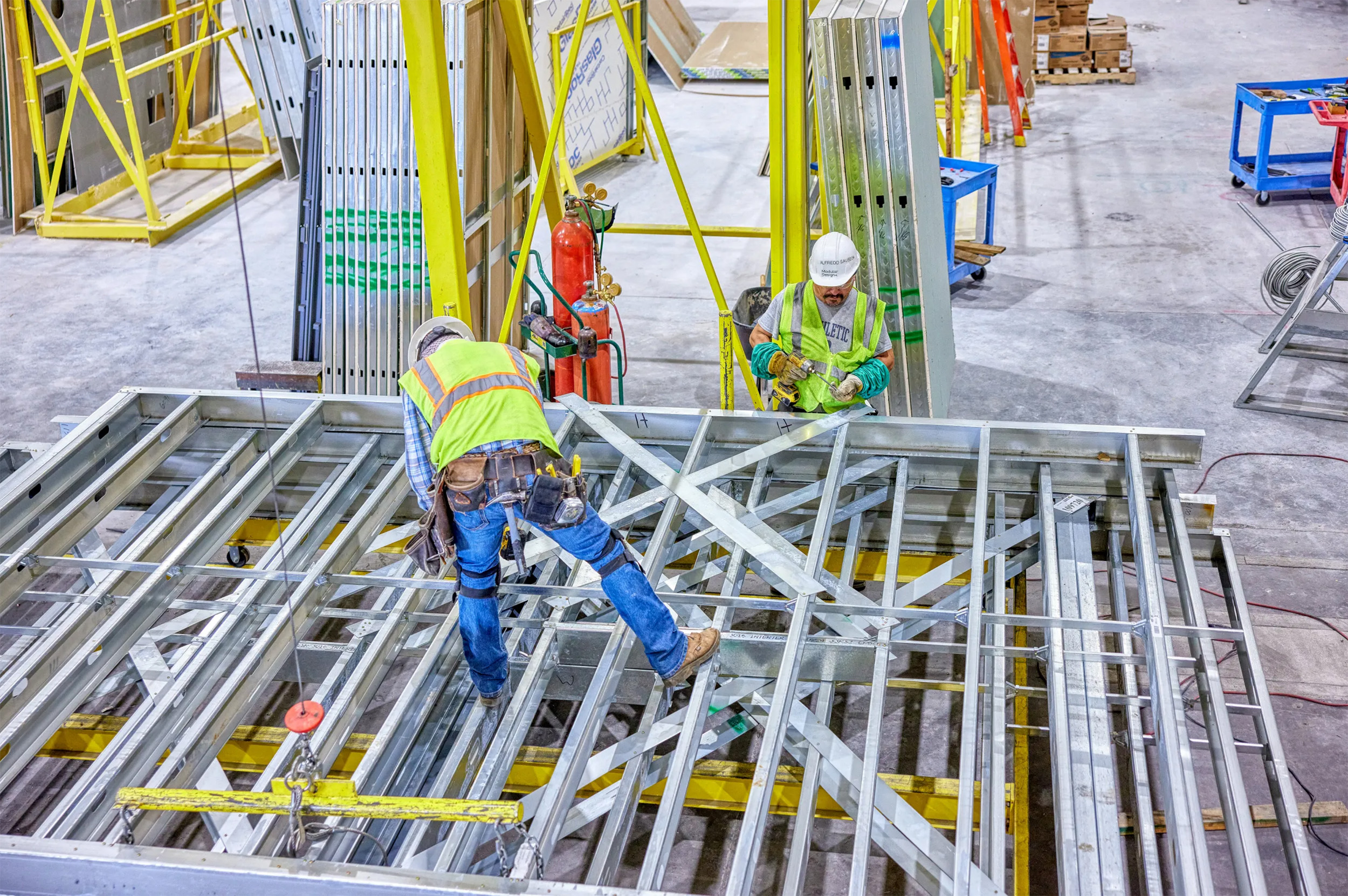 Load-bearing units and two workers in offsite construction factory