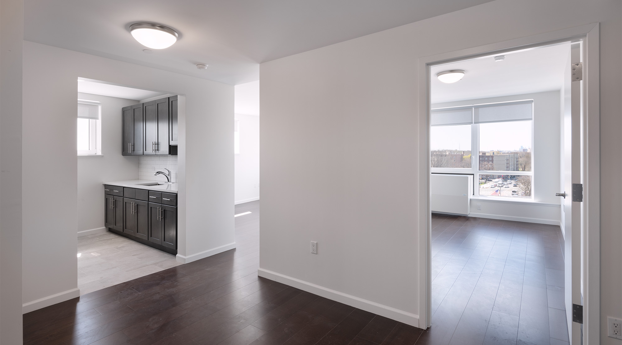 Thwaites Place white interior with dark wood floors and cabinets 