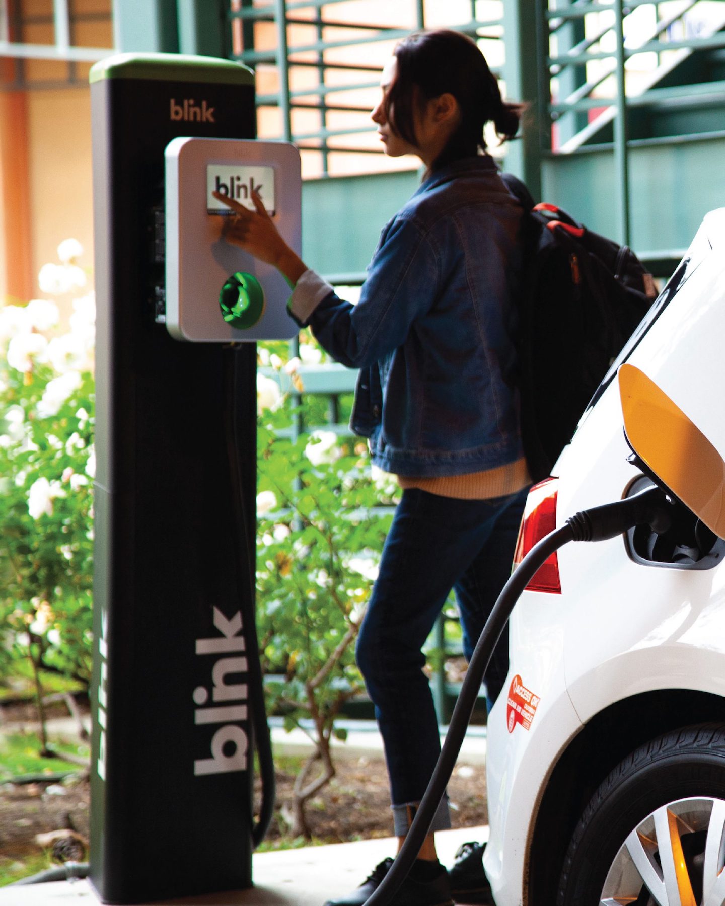   A customer using a Blink Charging charging station