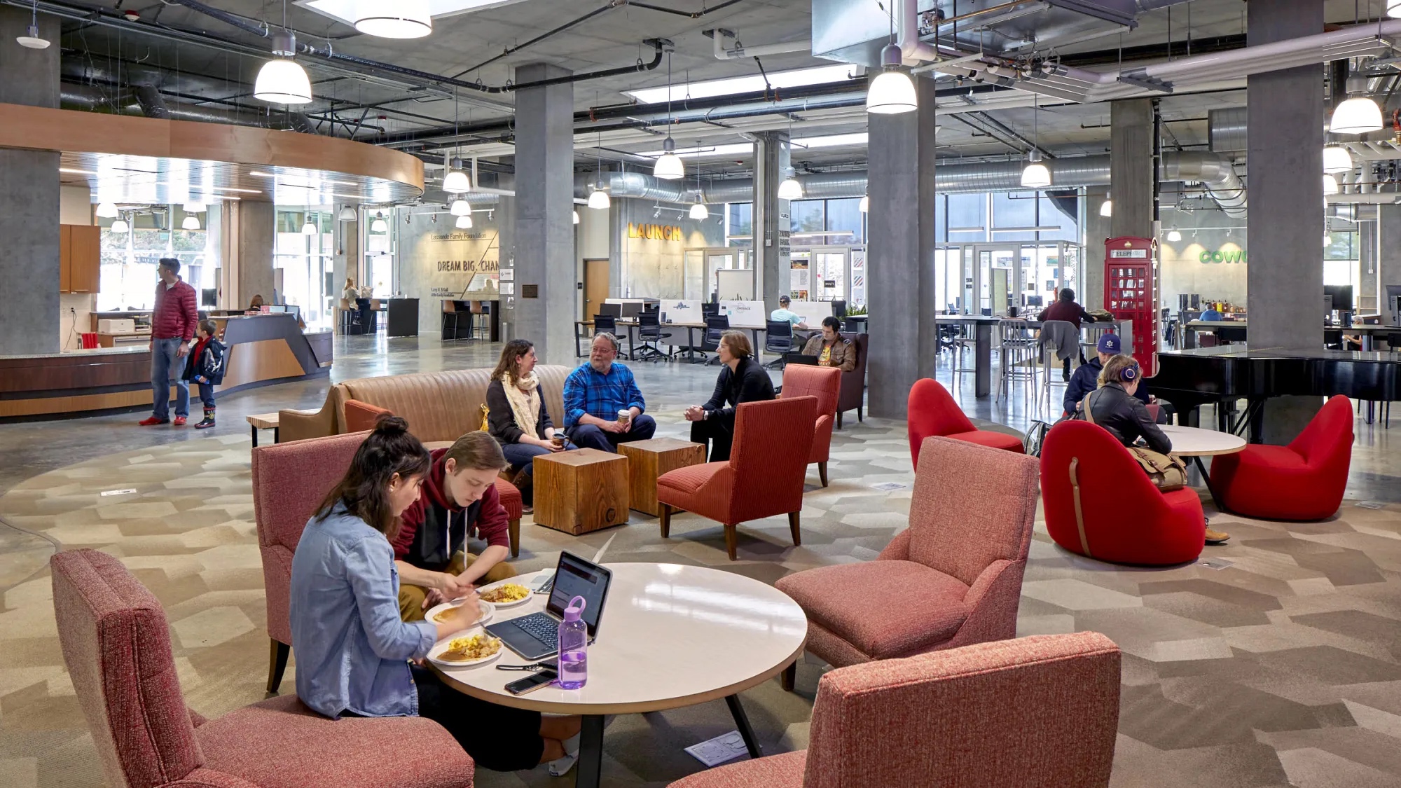 University students and faculty in large lounge studio