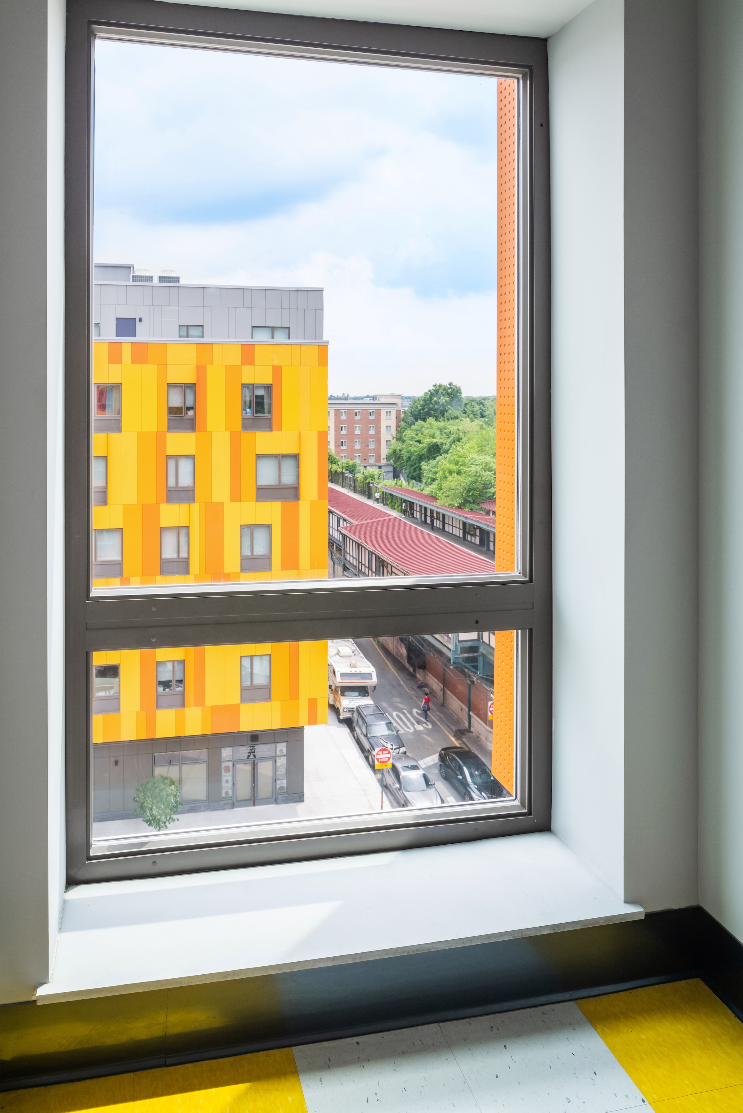 Brooklyn's colorful Van Sinderen Plaza affordable housing project includes retail, public spaces. Photo courtesy GLUCK+