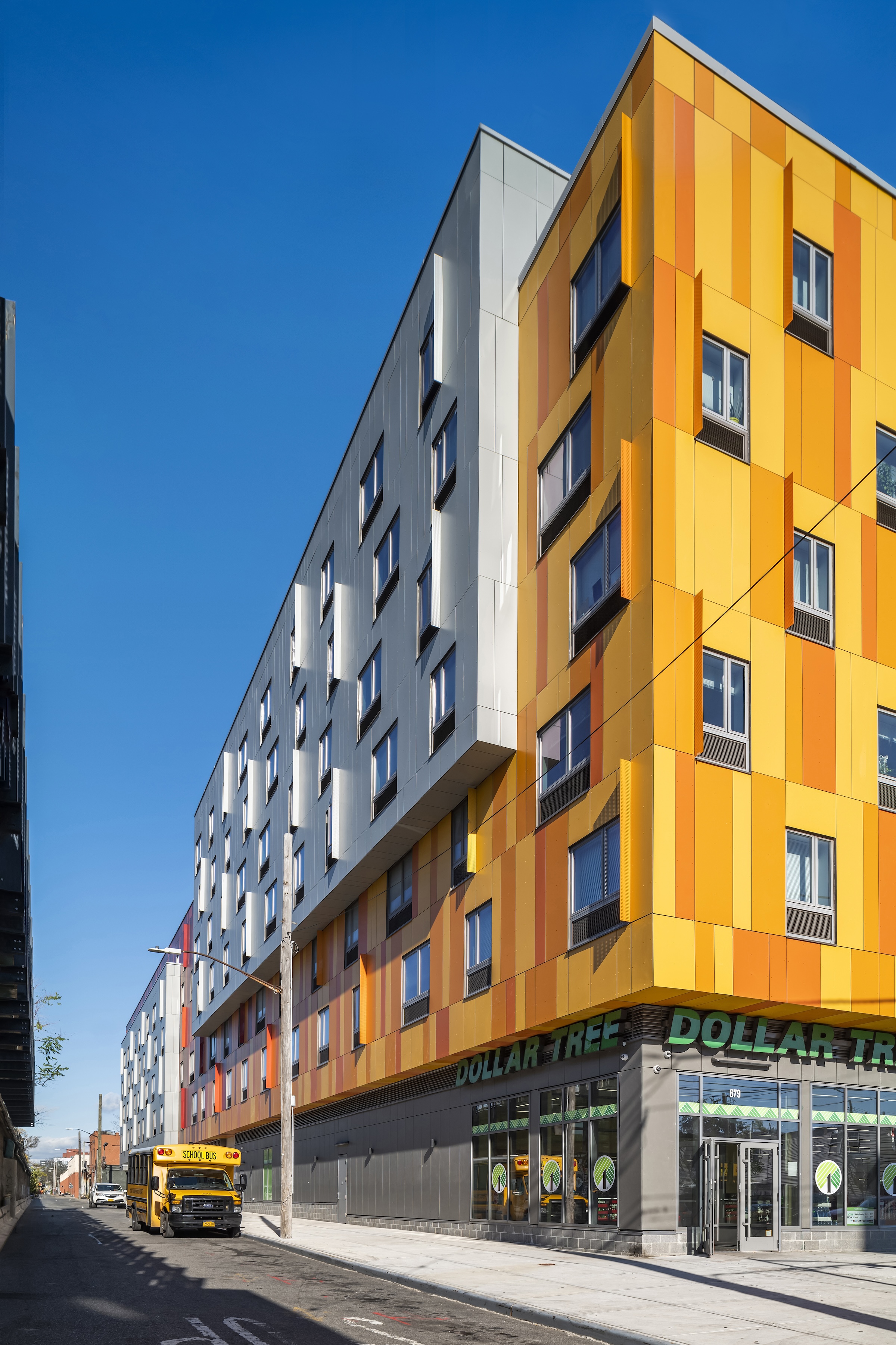 Brooklyn's colorful Van Sinderen Plaza affordable housing project includes retail, public spaces. Photo courtesy GLUCK+