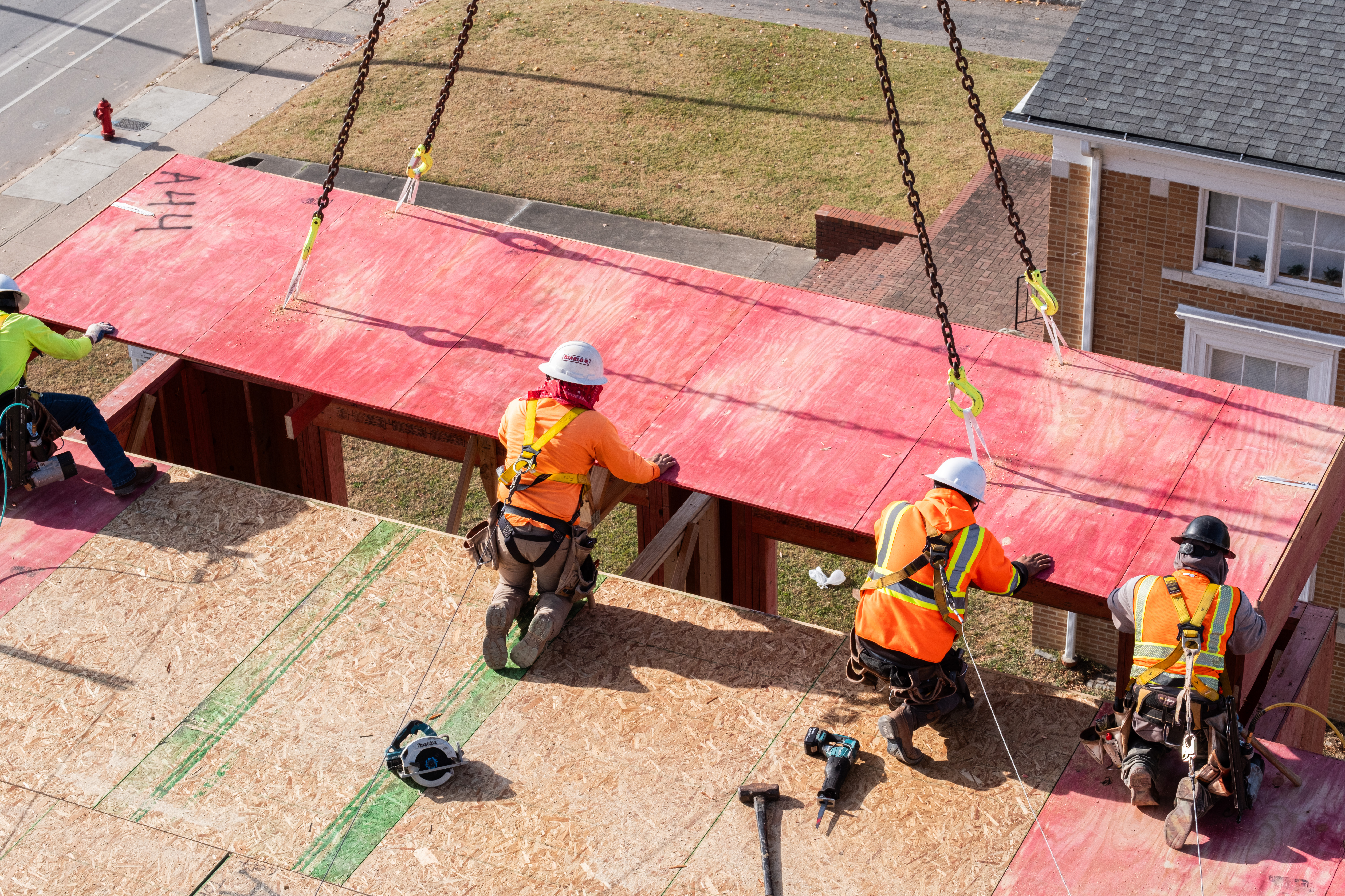 Crew installing ProWood fire-retardant wall components on a building under construction site in Durham, NC.