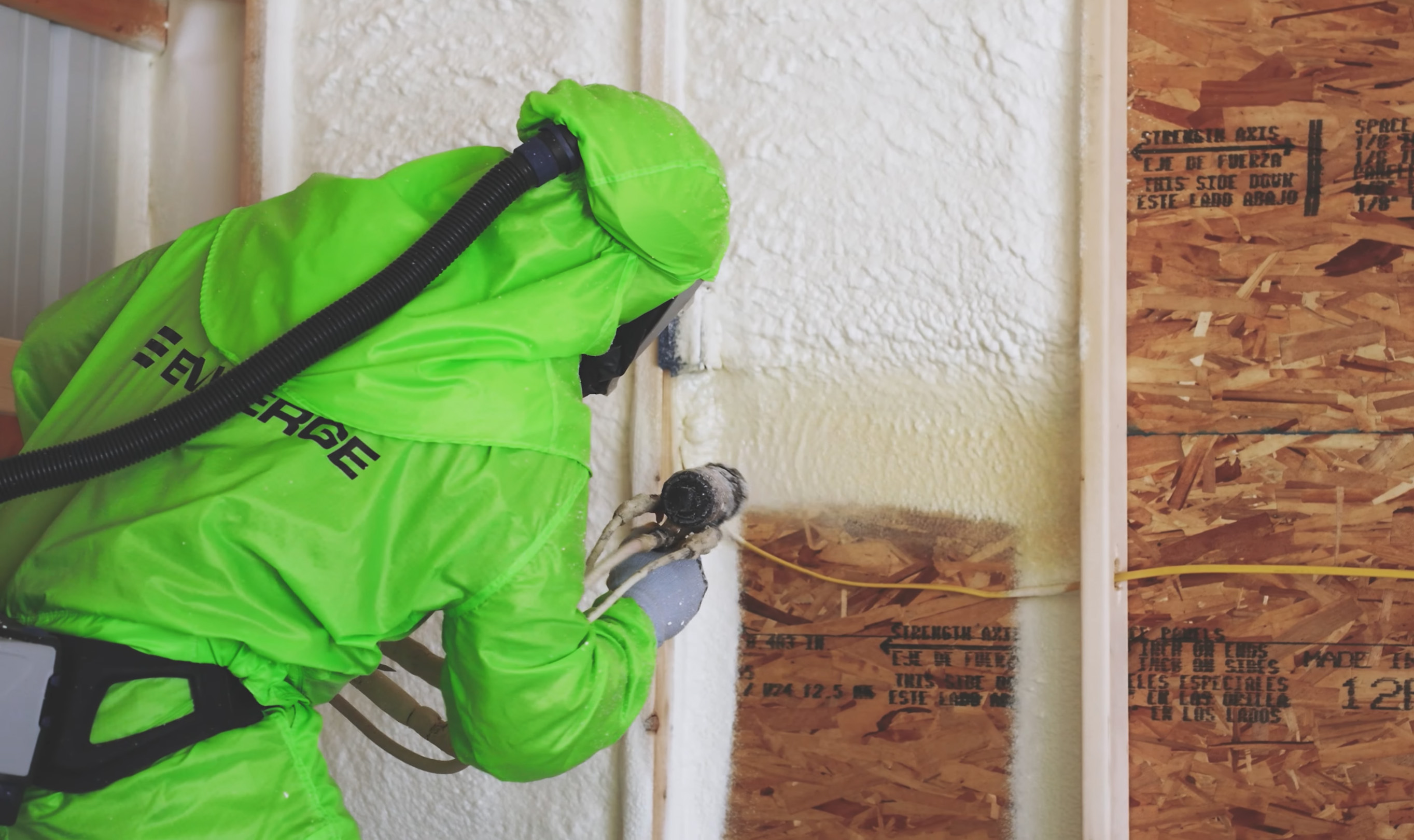 Man using spray foam insulation brand Enverge