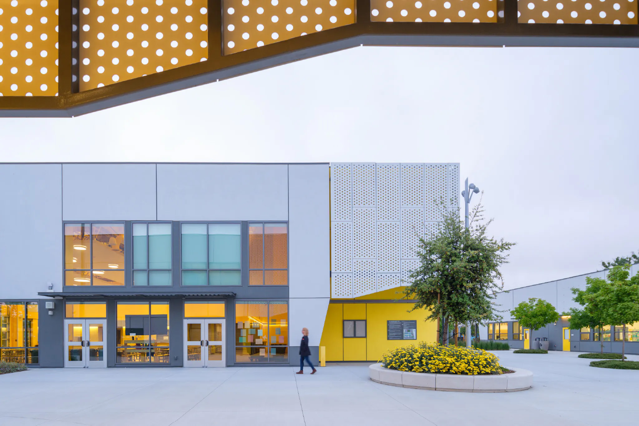 Metal scrims throughout the campus admit natural light while rejecting heat.