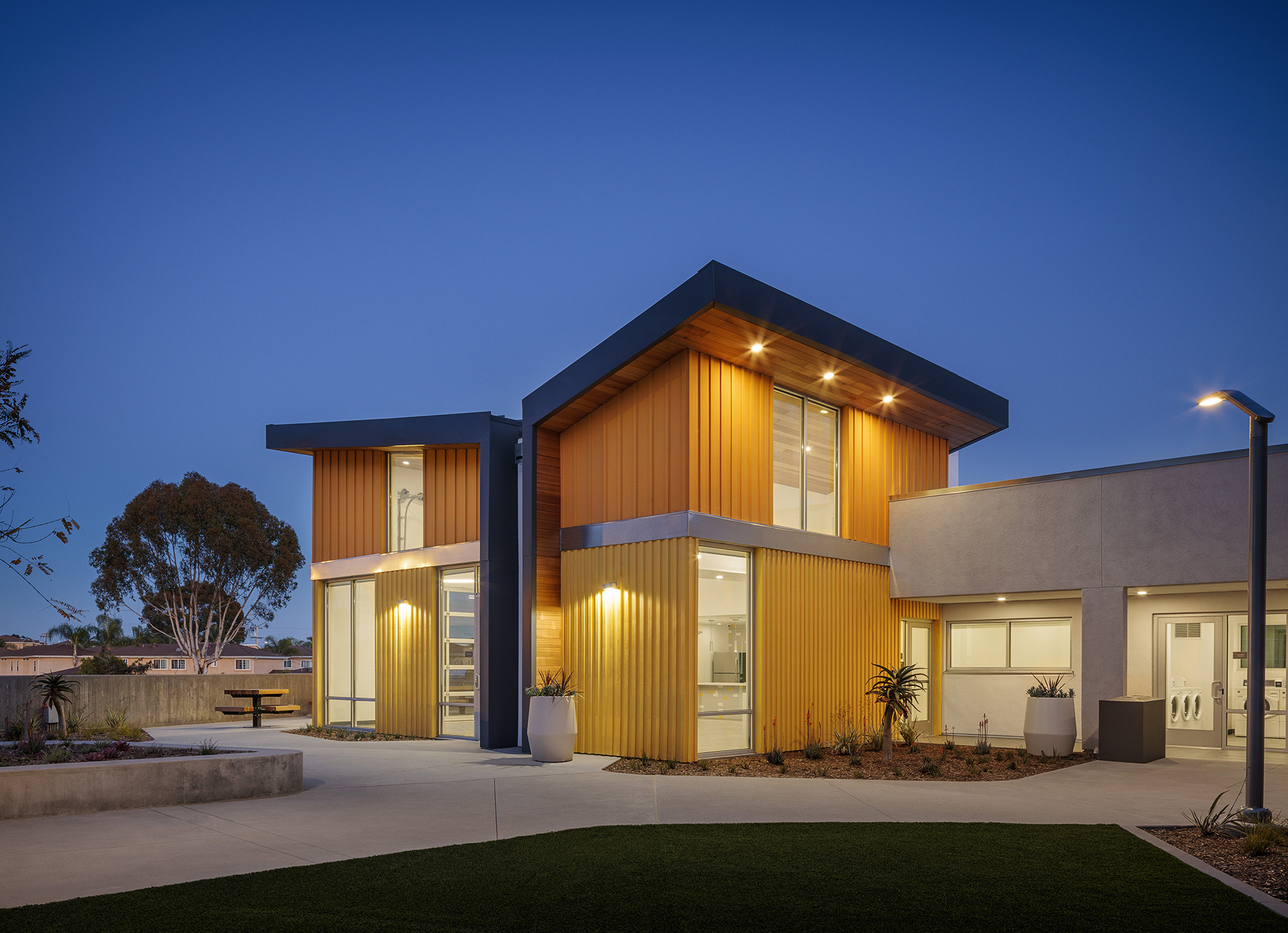 Puesta del Sol Apartments, San Diego exterior at night of affordable housing project