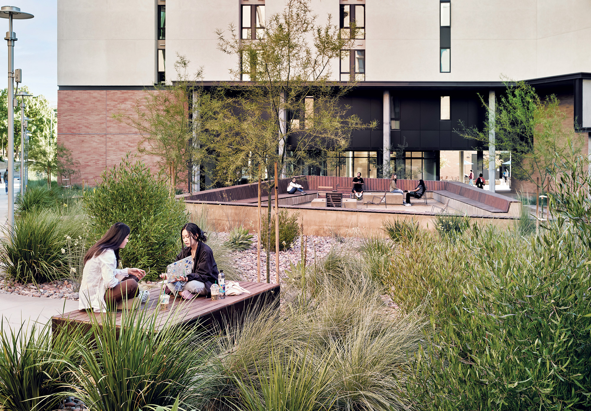 Residence hall exterior students studying