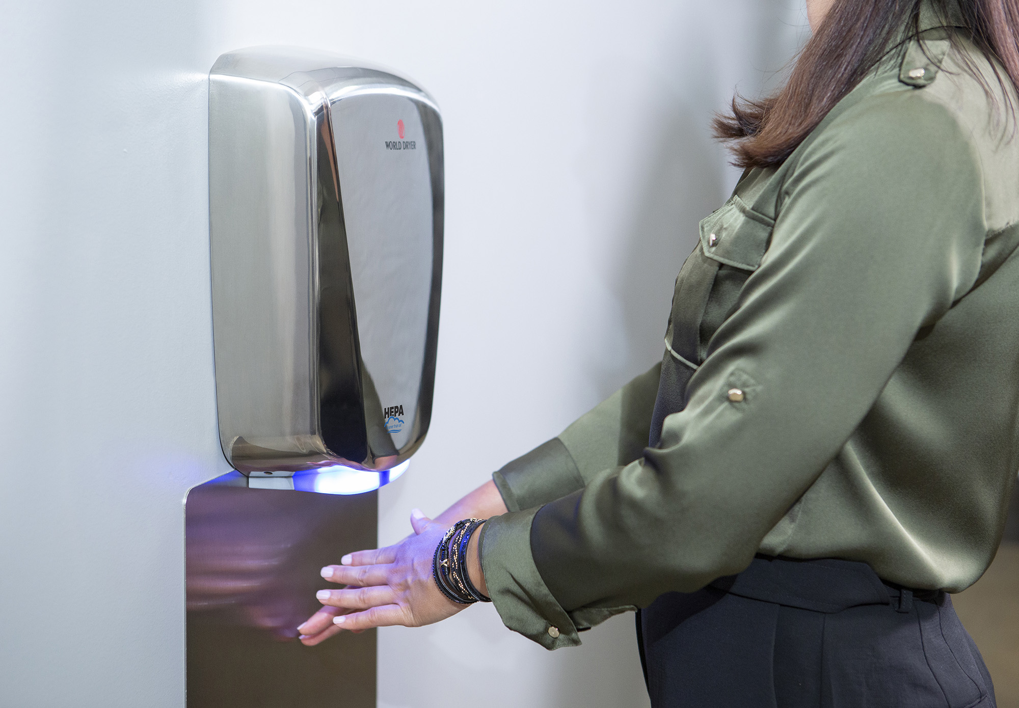 Woman using hand dryer