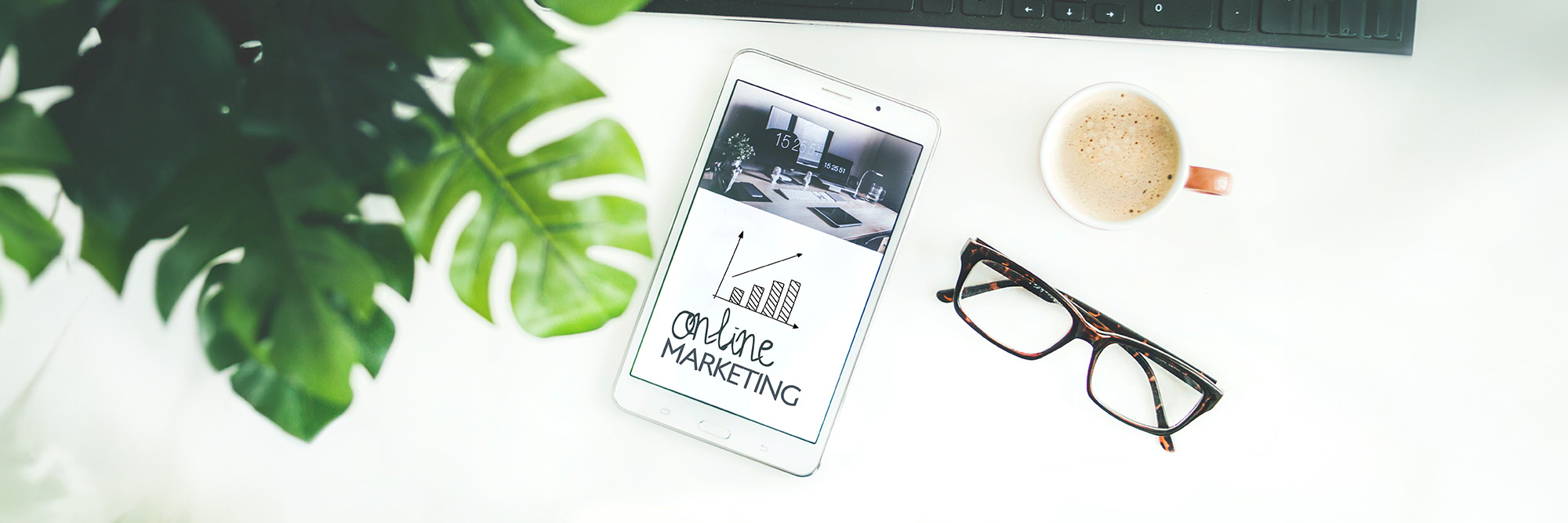 Online marketing on phone with Brown Framed Eyeglasses on desk