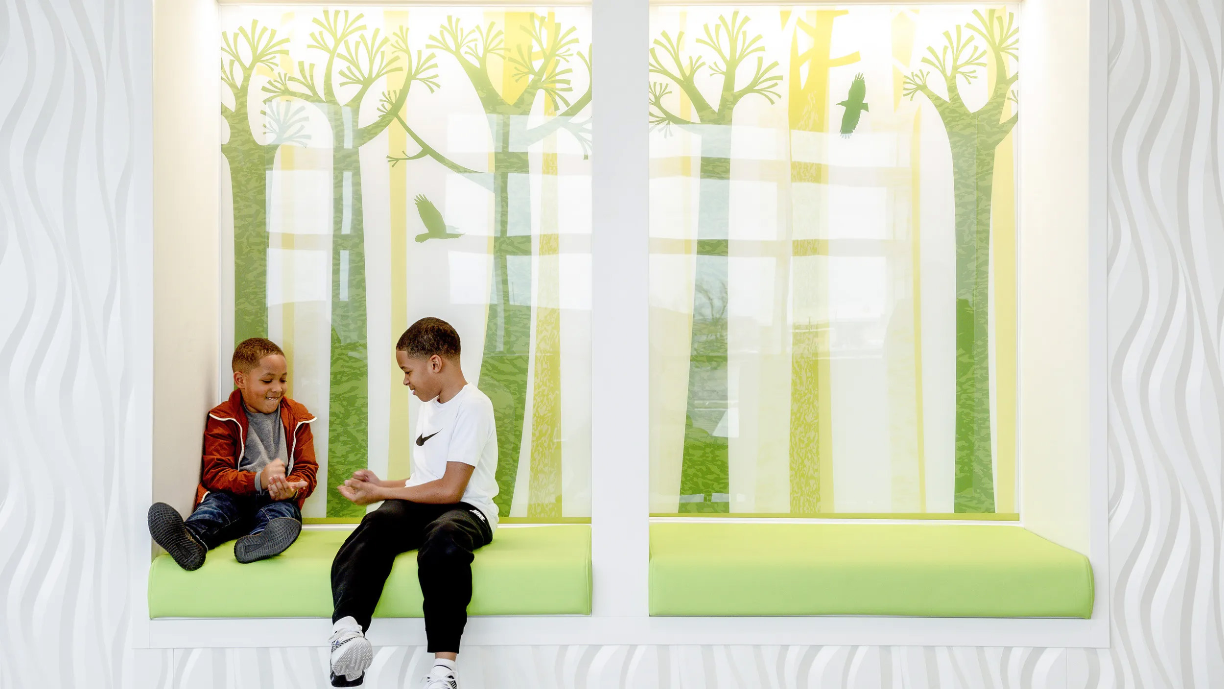 Two boys playing rock paper scissors in pediatric office 