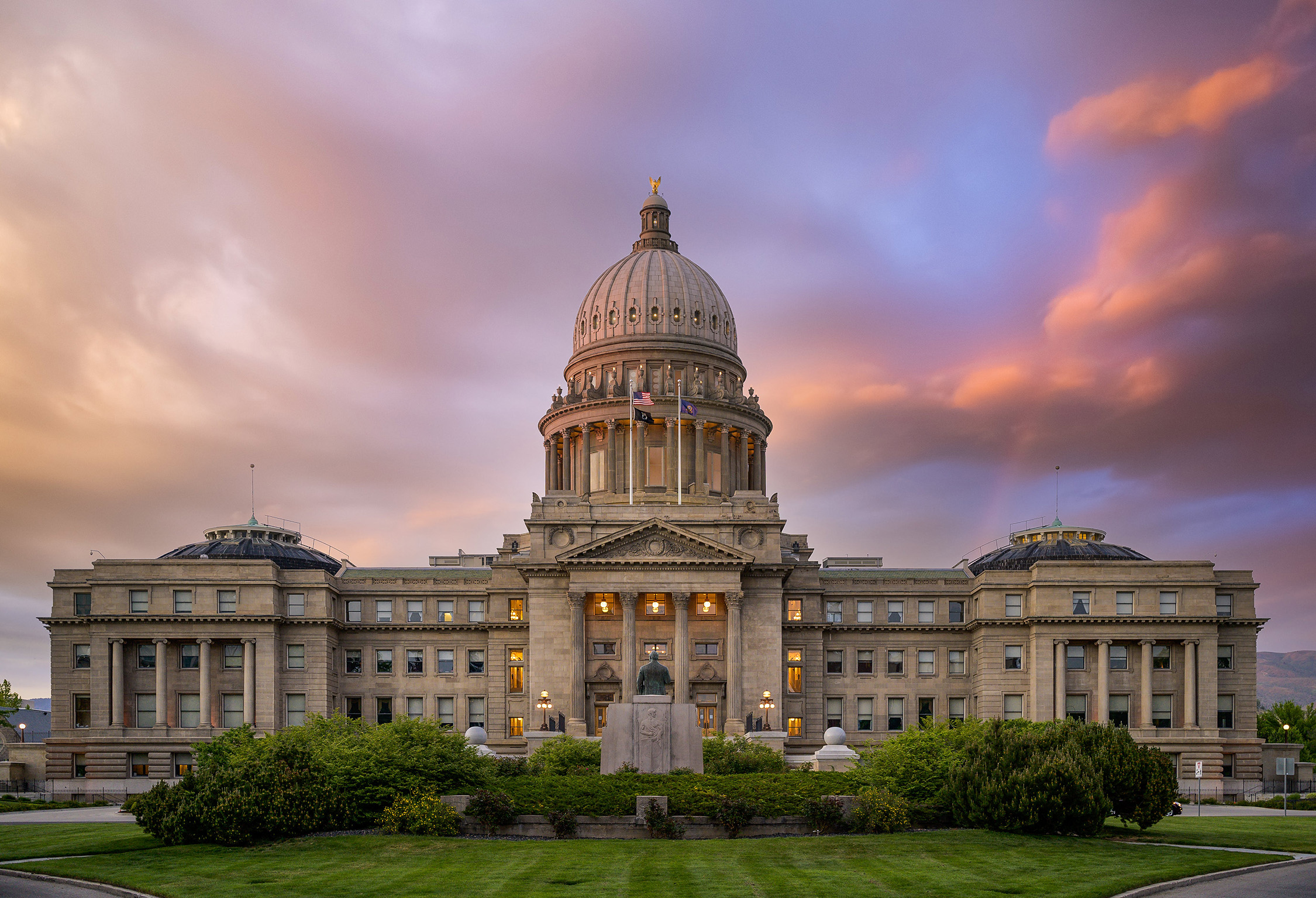 Facade of aged historic cathedral under colorful sky at sunset