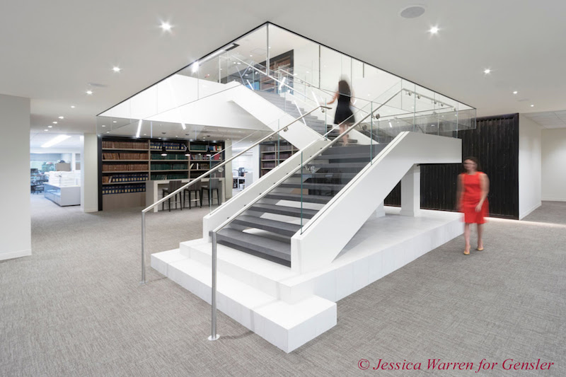 The tile and glass staircase that connects the two floors