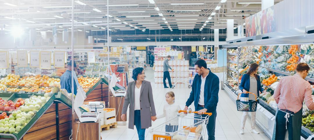 At the Supermarket: Happy Family of Three, Holding Hands, Walks Through Fresh Produce Section of the Store. Father, Mother and Daughter Having Fun Time Shopping. High Angle Panoramic Shot.