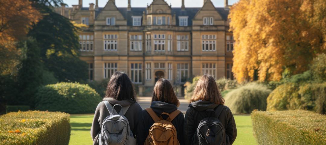 Students walk into a dormitory or college campus, viewed from the back