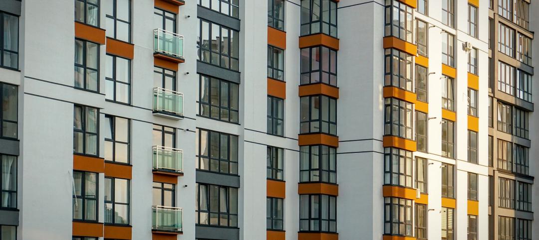 Facade of a multi-apartment residential building with windows and balconies