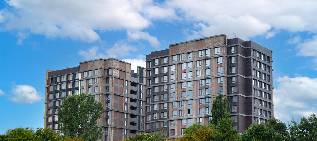 Brown modern apartment buildings over blue sky. New multifamily complex in Kyiv, buildings exterior and city life concepts