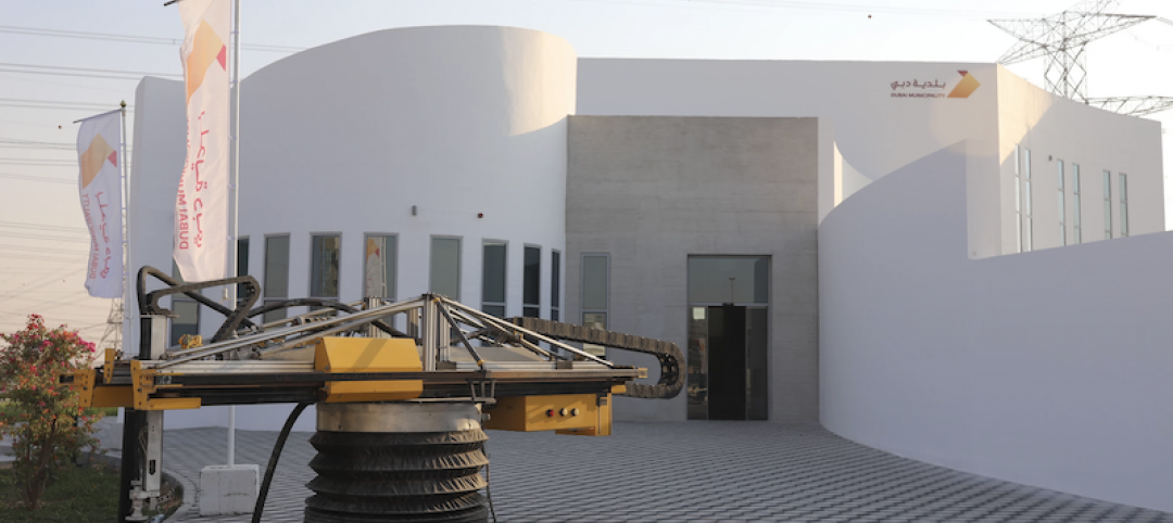 THe Apis Cor 3D printer in front of the completed building