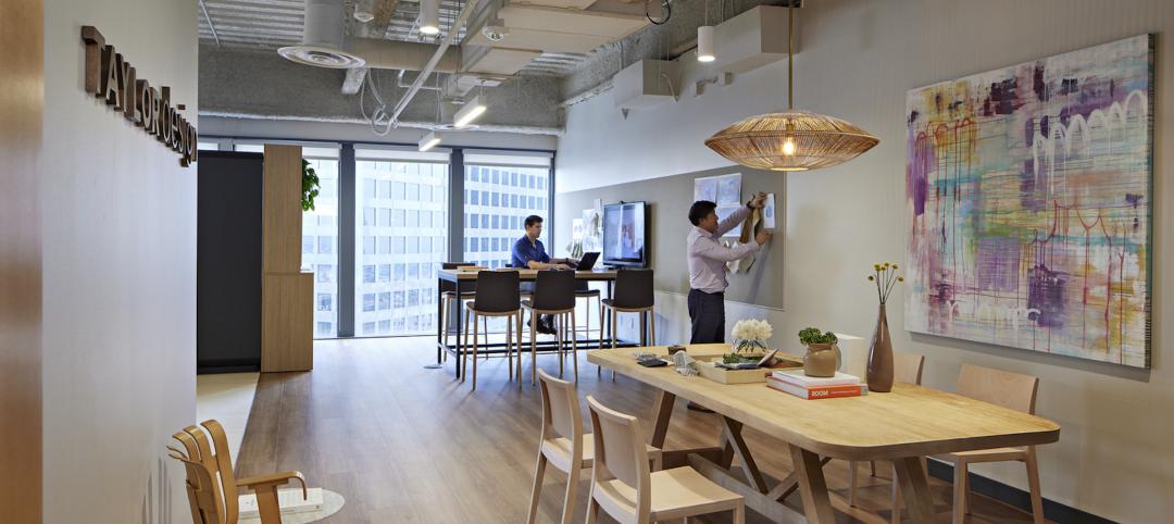 This photo of Taylor Design’s LA office shows standard branding, decorative lighting, and a family table (the 70%), with community art (the 30%) unique to the location.