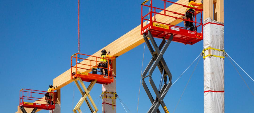 Workers put mass timber beams in place on a timber project in early construction stage. Photo: Marco Zecchin, Image Center