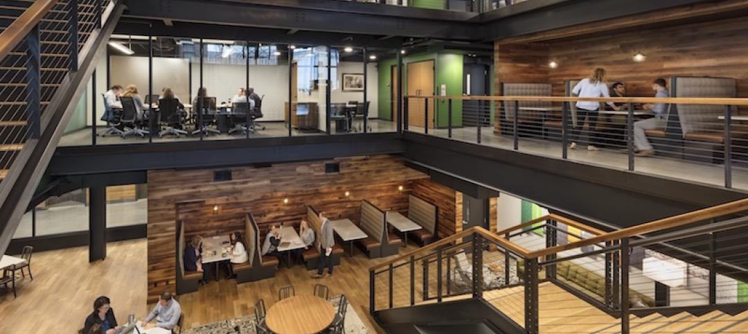 A glass-walled conference room overlooks the atrium.