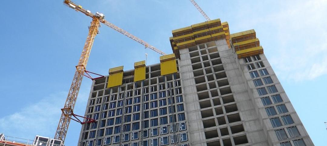 Building under construction and by cranes