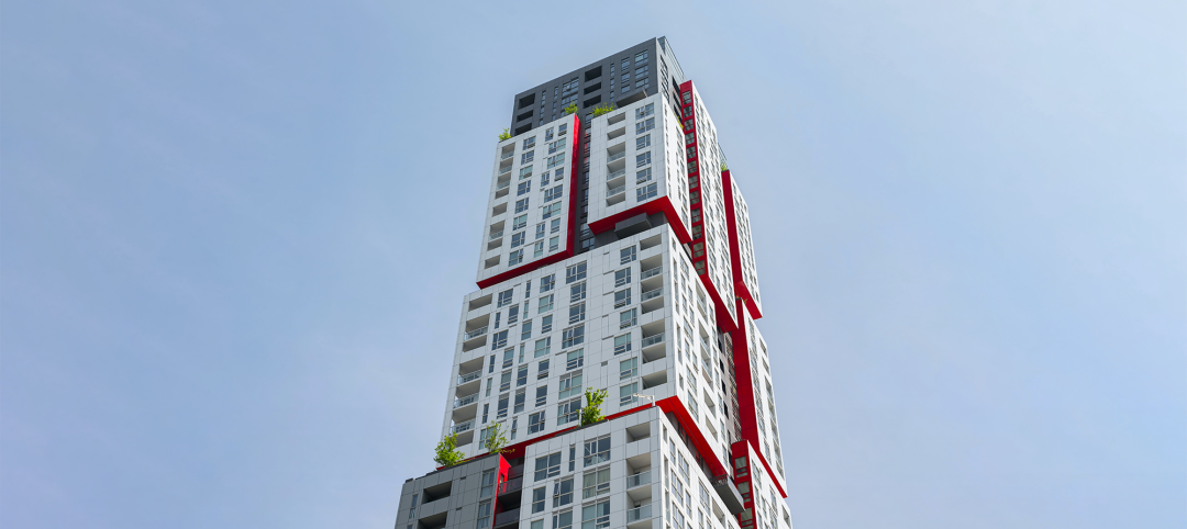 Tall modern apartment complex with blue sky