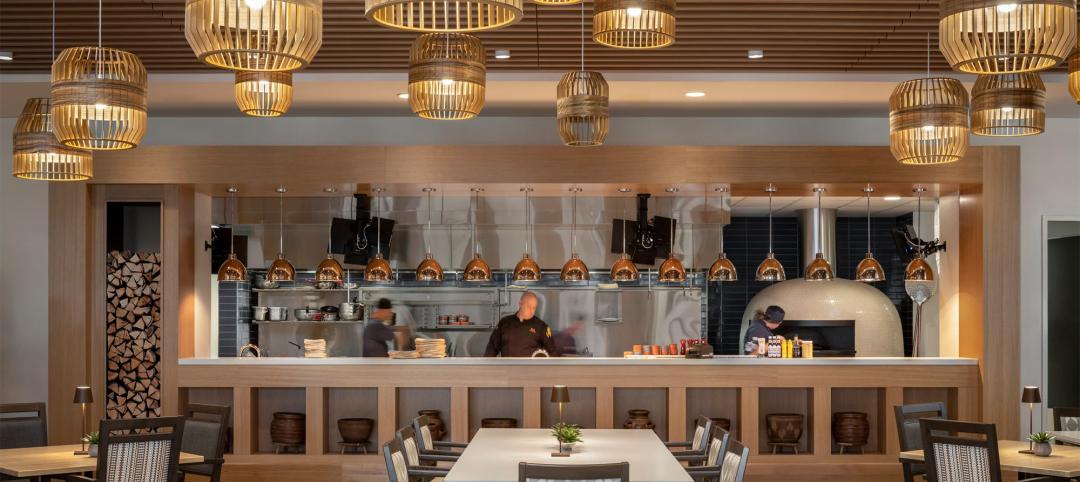 The Indigo Dining Room at Inspirata Pointe at Royal Oaks in Sun City, Arizona, a senior living community, features a large window into the kitchen